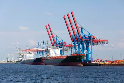 Container harbor with tall cranes and docked ships in Hamburg Harbor, Germany Stock Photos