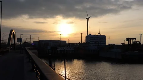 The container harbour of Hamburg at sunset with a windmill Stock Footage 231752778