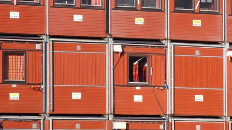 Container homes and offices on a construction site - red shipping containers Stock Footage 232090343