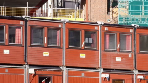 Container homes and offices on a construction site - red shipping containers Stock Footage 232097089