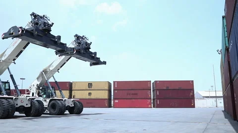 Container lifting and stacking at a busy shipping yard during daylight Stock Footage 318200917