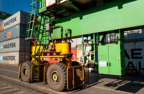 Container loader bridge with heavy tires in marine port Stock-Fotos