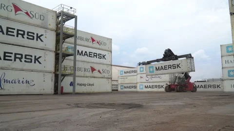 Container loader truck loading a large cargo storage container at a shipyard  Stock Footage 189466861