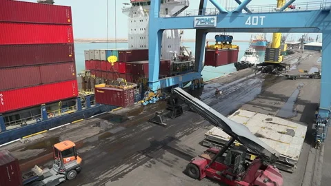 Container loading at a busy port with cranes and trucks in action Stock Footage 318203642