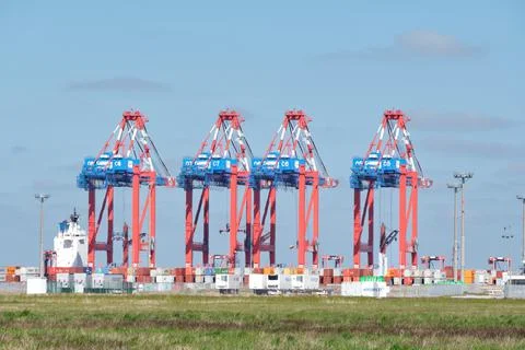 Container loading cranes in an industrial cargo port, Wilhelmshaven, Germany Stock Photos