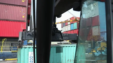 Container loading process at a busy shipping yard in broad daylight Stock Footage 318203125