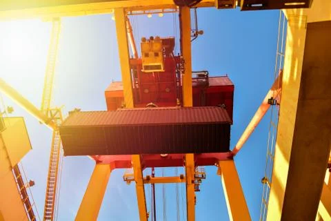 Container logistics, quay crane load and unload cargo container from vessel. Stock Photos