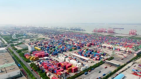 Container logistics yard with cranes along the riverfront in Shanghai Stock Footage 346585923