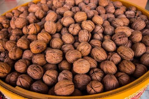 In the container is a lot of walnuts Stock Photos
