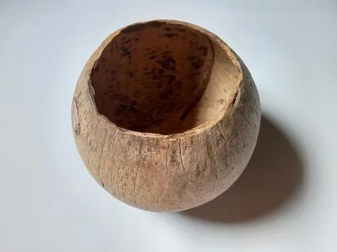 Container made of coconut shell, on a white background. Photos