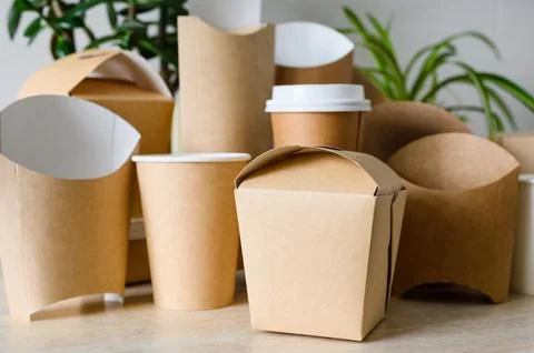 Container for noodles on a background of disposable tableware. Stock Photos