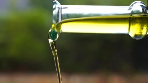 Container with olive oil pouring it Stock Footage 250765061