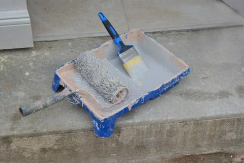 Container with paint roller and brush Stock-Fotos