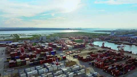 Container port basin beside rectangular water plots at Guangzhou Port Stock Footage 346447079