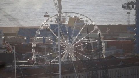 Container port with Ferris wheel in motion Stock Footage 126853586