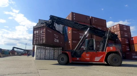 Container port terminal, working trucks, reachstacker, loading containers Video stock 128175756