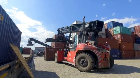 Container port terminal, working trucks, reachstacker, loading containers Video stock 128176111