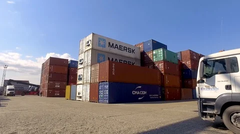Container port terminal, working trucks, reachstacker, loading containers Video stock 128176410