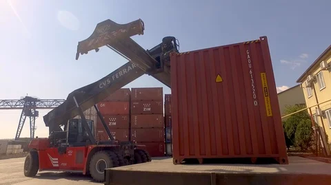 Container port terminal, working trucks, reachstacker, loading containers Stock Footage
