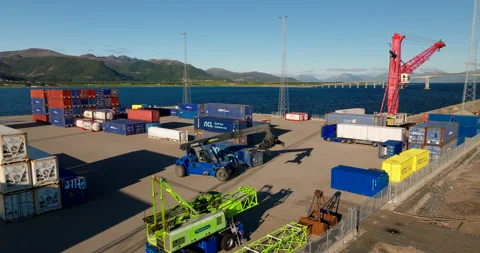 Container reach stacker maneuvers in freight yard of Miljohavn Stokmarknes. Stock Footage 336743659
