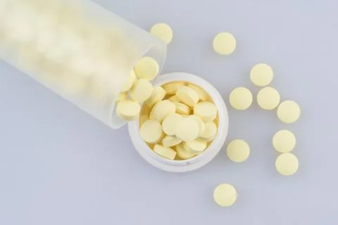 Container with scattered pills Stock Photos