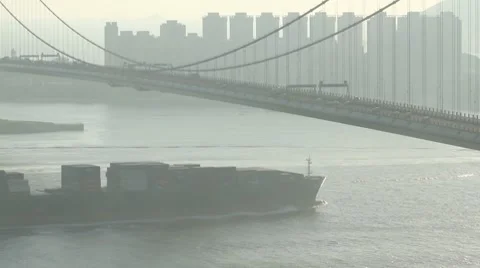 Container ship across the tsing ma bridge at dusk Stock Footage 8510782
