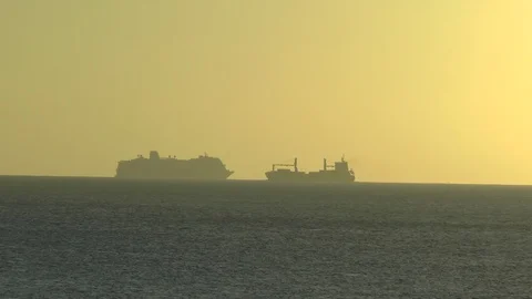 Container ship and Cruise Liner In A Caribbean Sunset Stock Footage 106814349