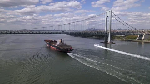 Container ship and passenger ship sail under the Verrazzano Bridge to New York Stock Footage 240688458