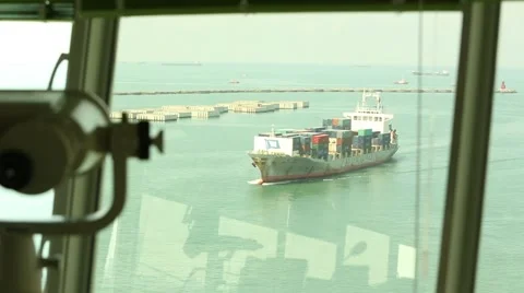 A container ship is arriving at port, viewed from vessel traffic service center. Stock Footage 66452646