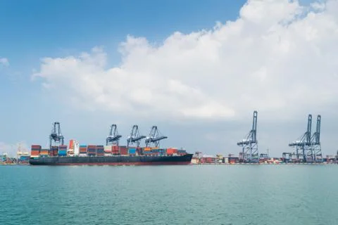 Container ship in asia port while load the job with blue sky Stock Photos