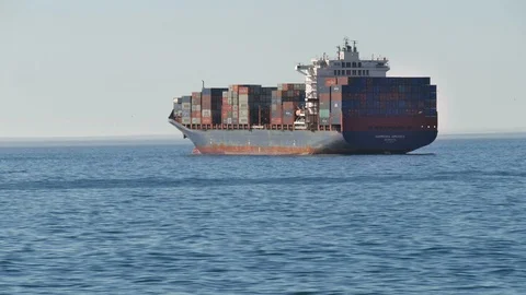 Container ship from back oblique view on calm flat sea 動画素材 102611620