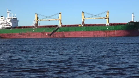 Container ship with crane constructions sails slowly Stock Footage 113090390