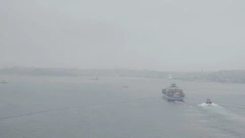 Container ship crossing the Bosphorus on a foggy day Stock Footage 166403972