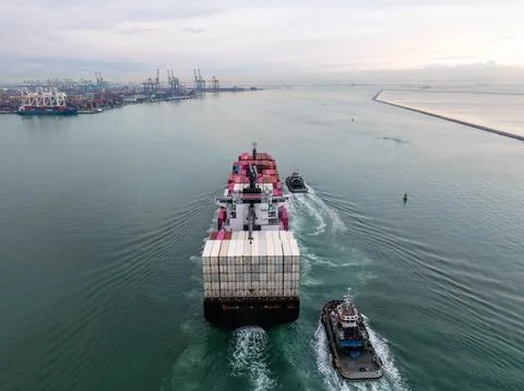 Container Ship Entering Harbor Guided By Tugboats Wide Angle View Stock Photos