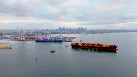 Container ship entering Port of Melbourne with city skyline Stock Footage 331548482