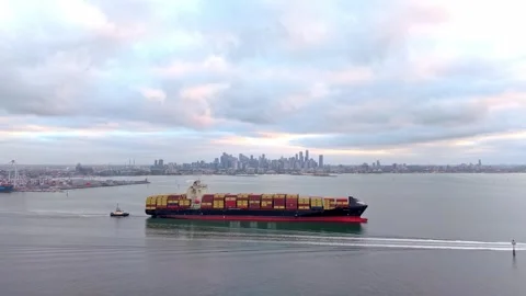 Container ship entering Port of Melbourne with city skyline Stock Footage 331548490