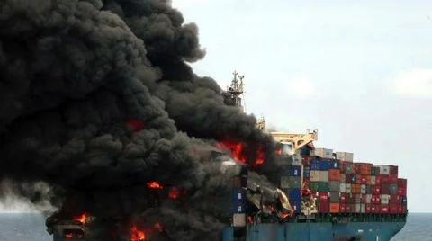 Container Ship on Fire at Sea with Thick Black Smoke and Moving Flames 動画素材 143410617