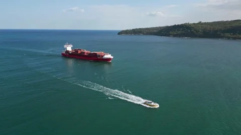A container ship at full speed is approaching the seaport, aerial view Video stock 252134417