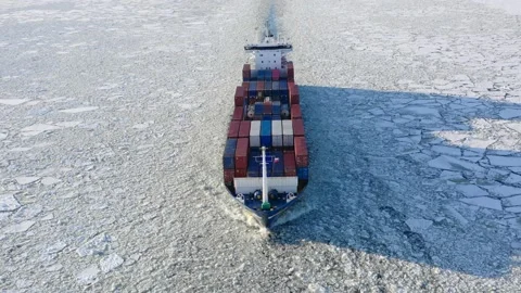 Container ship goes through the ice floes, aerial view Stock Footage 170384946