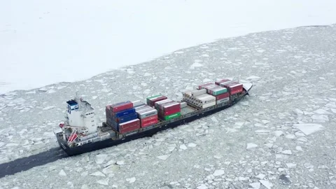 Container ship goes through the ice floes in baltic sea, aerial view Stock Footage 170384974