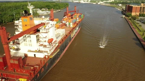 Container Ship Guided by Tug Boat in Savannah River Channel Stock Footage 245320424