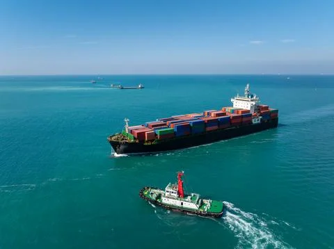 Container Ship Guided By Tugboat Navigating Through Coastal Waters Near Si .. Stock Photos