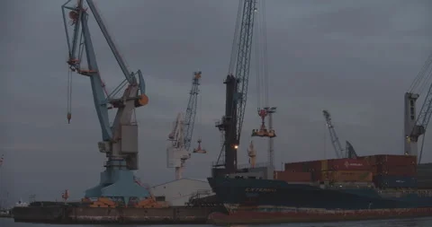 Container Ship at Hamburg Harbour offloading with a crane Stock Footage 134491640