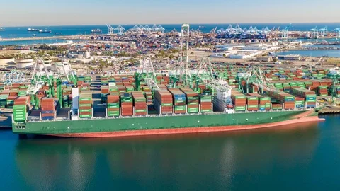 Container ship in harbor unloading trade cargo containers with cranes Stock Footage 99011730