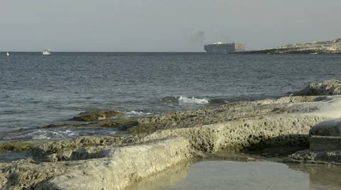 Container ship leave Malta free port near Marsaxlokk salt 動画素材 64554105