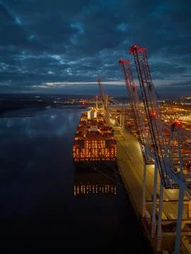Container ship lights reflection at dusk aerial in Southampton Docks UK Stock Photos