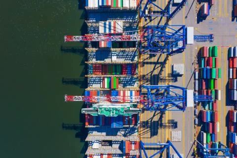 Container ship loading at port with crane, container ship carrying container  Stock Photos