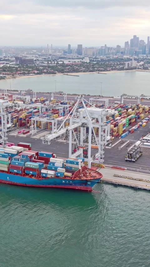 Container ship loading at Port of Melbourne with city skyline Stock Footage 332778254