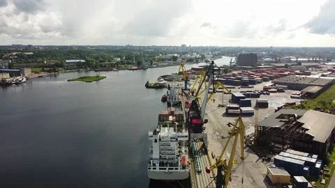 Container ship on loading in the seaport, rear view from a height Stock Footage 194019911