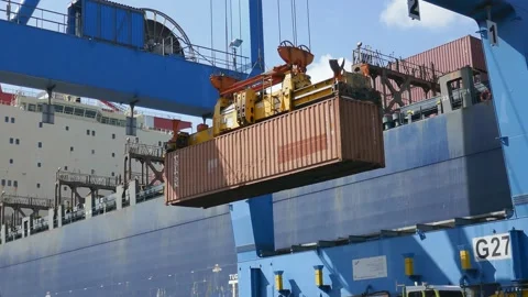 Container ship loading / unloading by industrial line gantry crane 4k creative b Stock Footage 140609914